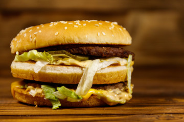 Delicious big hamburger on wooden table
