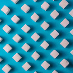 Food background with sugar on blue color paper.