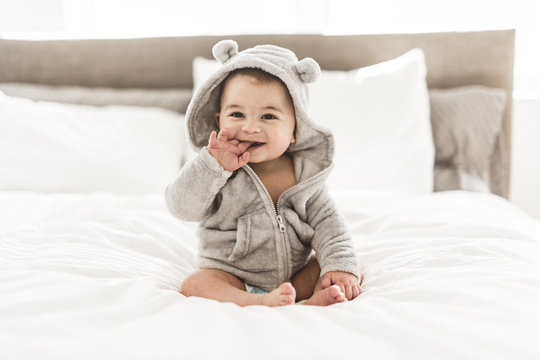Portrait of a baby boy on the bed in bedroom