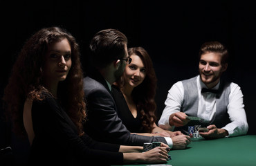 players sitting at the playing table in the casino