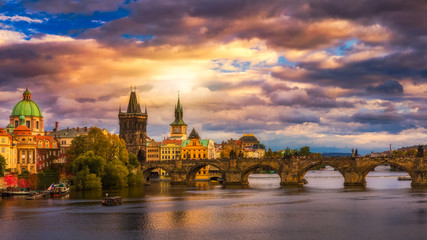 Obraz premium Słynny most Karola w świetle zachodzącego słońca, piękna sceneria i jeden z kultowych zabytków Pragi. Republika Czeska.