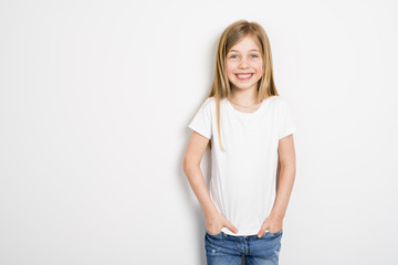 Happy small five years old girl with straight hair over white background at home