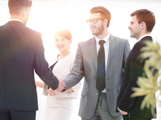 handshake business partners in the office