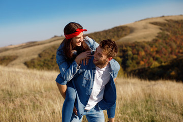 Happy young couple enjoys a sunny day in nature