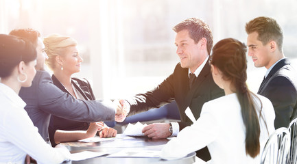two business partners shaking hands on meeting