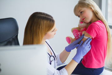 Pediatrician. Brave little girl receiving injection