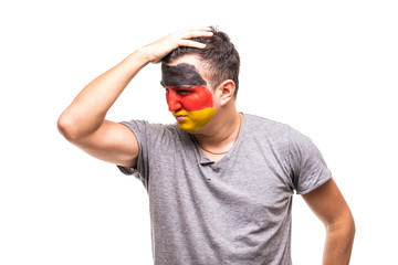 Handsome man supporter fan of Germany national team painted flag face get unhappy sad frustrated...