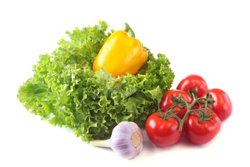 Fresh assorted vegetables bell pepper, tomato, garlic with leaf lettuce. Isolated on white background. Selective focus.