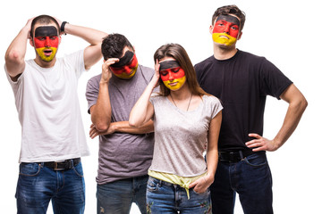 Group of people supporters fans of Germany national teams with painted flag face sad frustrated...
