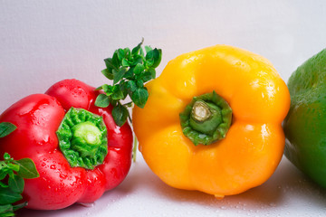 Yellow and red pepper with basil, close-up.