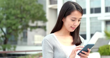 Woman read on smart phone in city