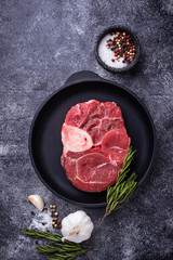 Raw meat osso buco with spices 
