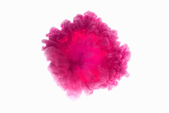 Color drop in water, photographed in motion. Abstract swirling. Cloud of silky bulb under water isolated on white background. Pink paint