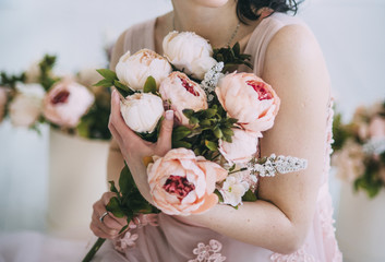 woman is holding flowers in beautiful dress