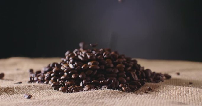 Dolly Shot Of Coffee Beans Falling On Hessian Sack 4K
