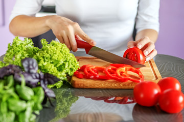 Woman cuts vegetables in the kitchen. Hands. The concept is healthy food, diet, vegetarianism, weight loss.