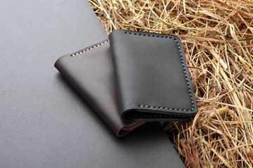 Set of two brown and and black card holder. Hand made leather man card holder. Multi colored. Leather craft.On creative background .Top view