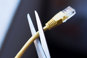 Scissors cutting the network cable