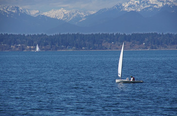 Sailboat on Puget Sound with Olympic mountains