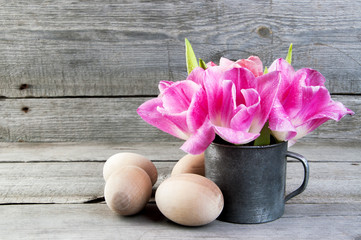 Pink tulips in vintage metal cup