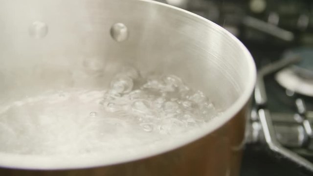 Closeup Of Water Boiling In Saucepan At Kitchen
