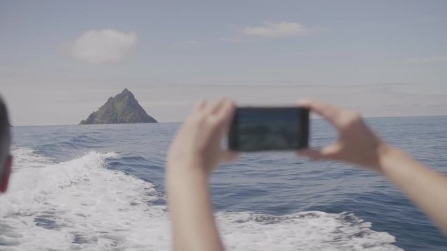 Woman On Boat Filming Skellig Michael Island With Smartphone