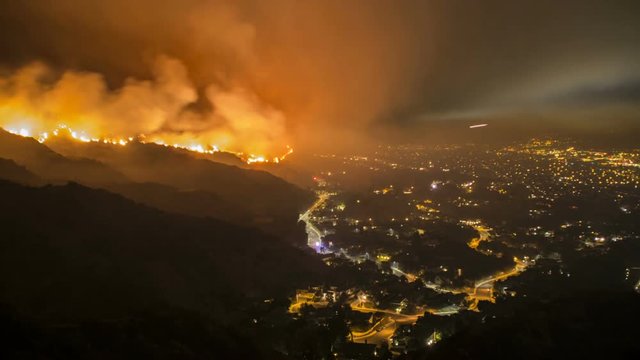Rescue teams evacuating neighborhood from wildfire - time lapse