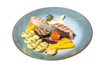 fried fish with garnish of vegetables isolated on white background