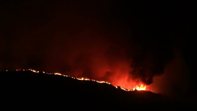 Giant flames in California wildfire at night