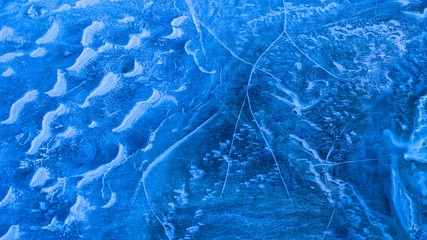 Ice on the lake. Ice from a height. A big crack in the ice. The texture of ice.