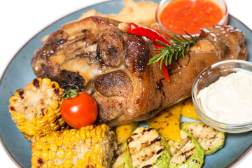 a large piece of meat with corn and potatoes