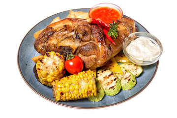 a large piece of meat with corn and potatoes