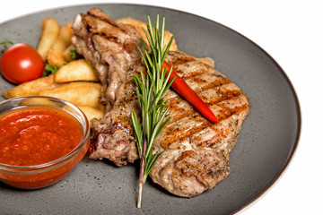 fried meat with garnish of potatoes isolated on white background