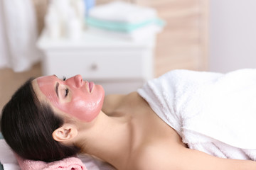 Obraz na płótnie Canvas Young beautiful woman having cosmetic mask in spa salon