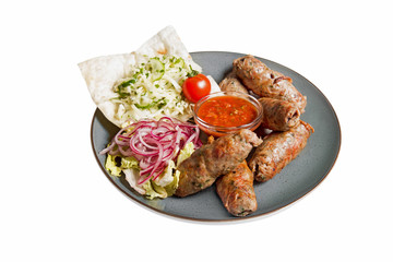 grilled sausages with garnish of vegetables and sauce