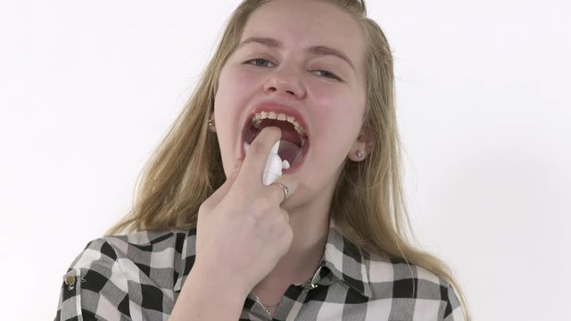 Oral hygiene for braces. Young girl with dental braces cleans her teeth. Teen girl cleaning and brushing teeth with clear ceramic braces using special brushing tools.