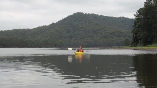 Man kayaking on river in Australia