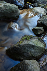 Fototapeta na wymiar Small stream and rocks at spring forest