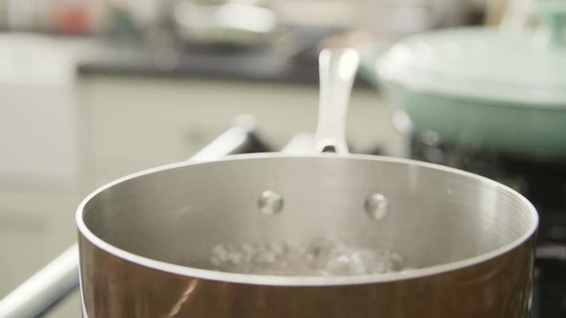 Closeup Of Water Boiling In Cookware At Kitchen
