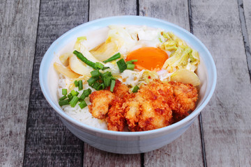 Jasmine rice with deep fried Chicken topped  soft boil eggs and fried pork with mixed vegetablein Japanese style.