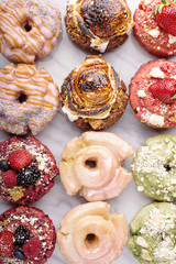 Variety of donuts on a marble surface
