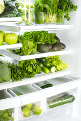 Fresh green vegetables and fruits in fridge.
