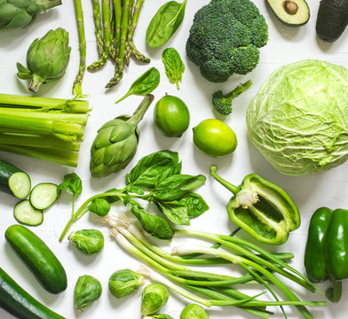 Fototapeta Green vegetables on a wooden background. Healthy food.