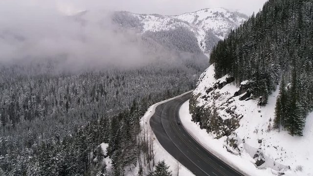 Winter Highway Roadtrip Aerial in Snowy Mountain Forest