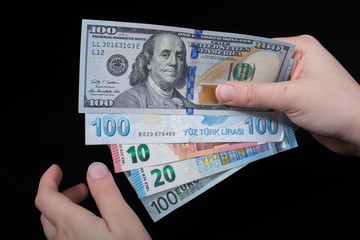 Hand holding American dollar  isolated on black background