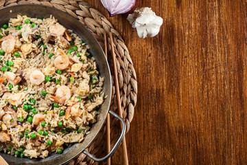 Fried rice with shrimp and vegetables on a frying pan