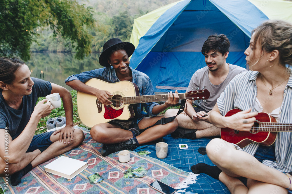 Wall mural group of young adult friends at camp site