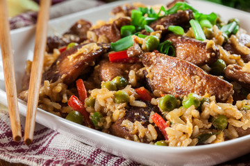 Fried rice with chicken and vegetables served on a plate