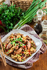 Fried rice with chicken and vegetables served on a plate