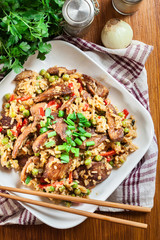 Fried rice with chicken and vegetables served on a plate